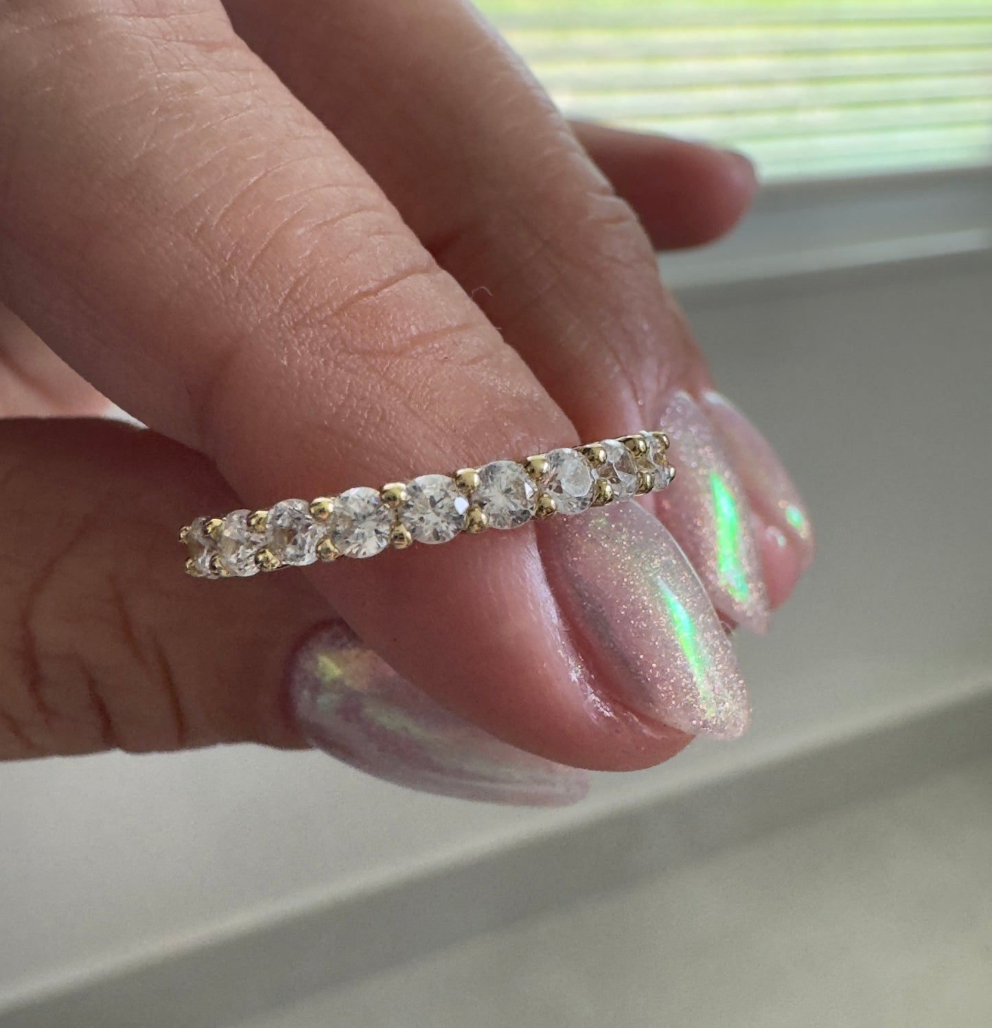 A timeless eternity band featuring sparkling clear stones set in 14KT gold plating. Elegant, stackable, and made for everyday wear.