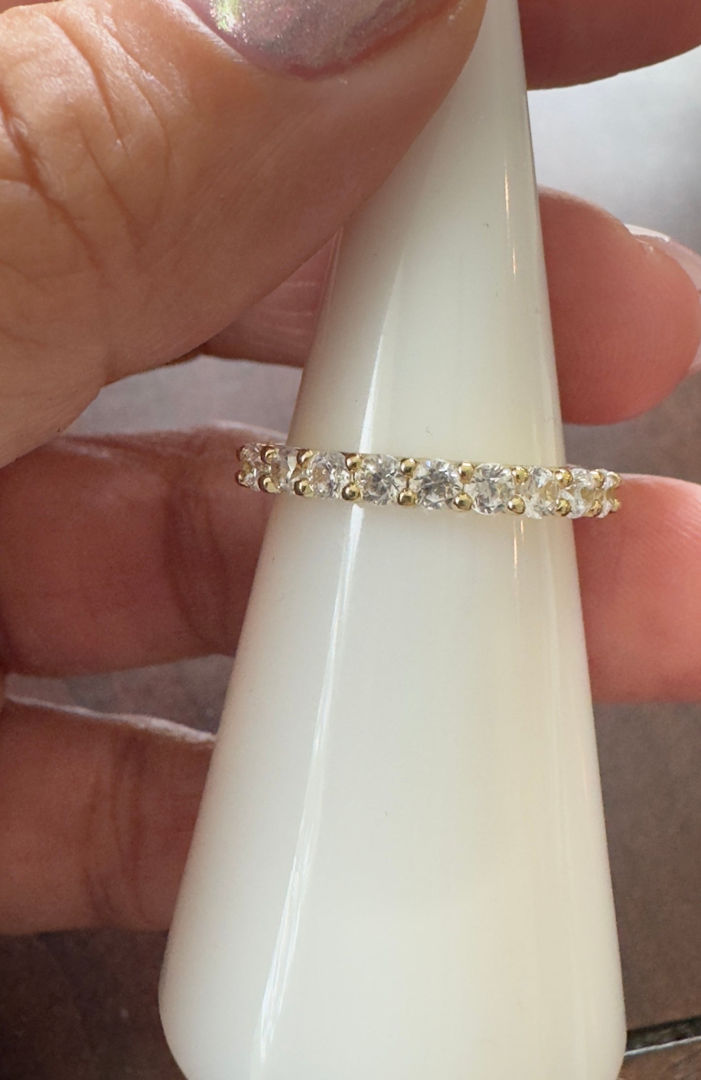 A timeless eternity band featuring sparkling clear stones set in 14KT gold plating. Elegant, stackable, and made for everyday wear.