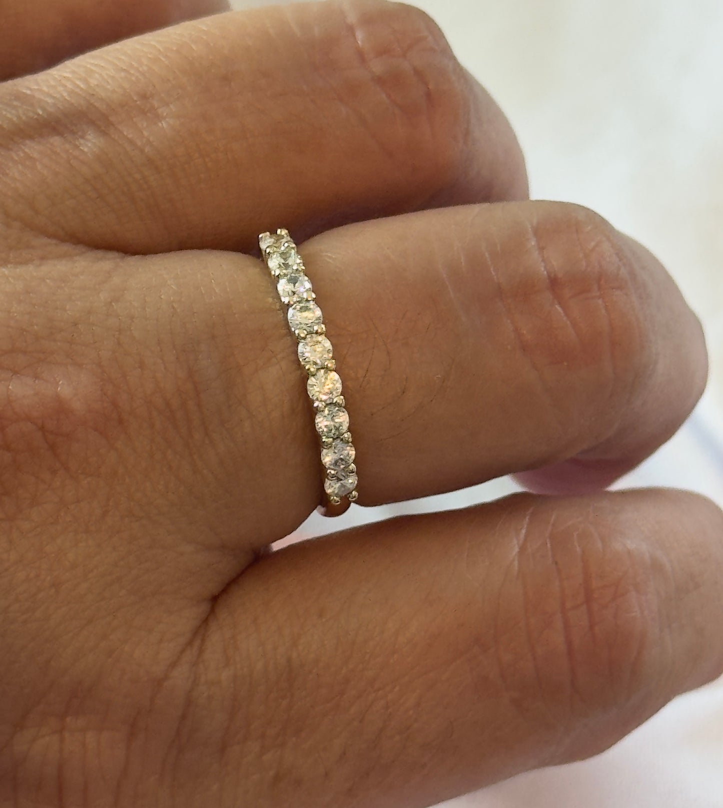 A timeless eternity band featuring sparkling clear stones set in 14KT gold plating. Elegant, stackable, and made for everyday wear.