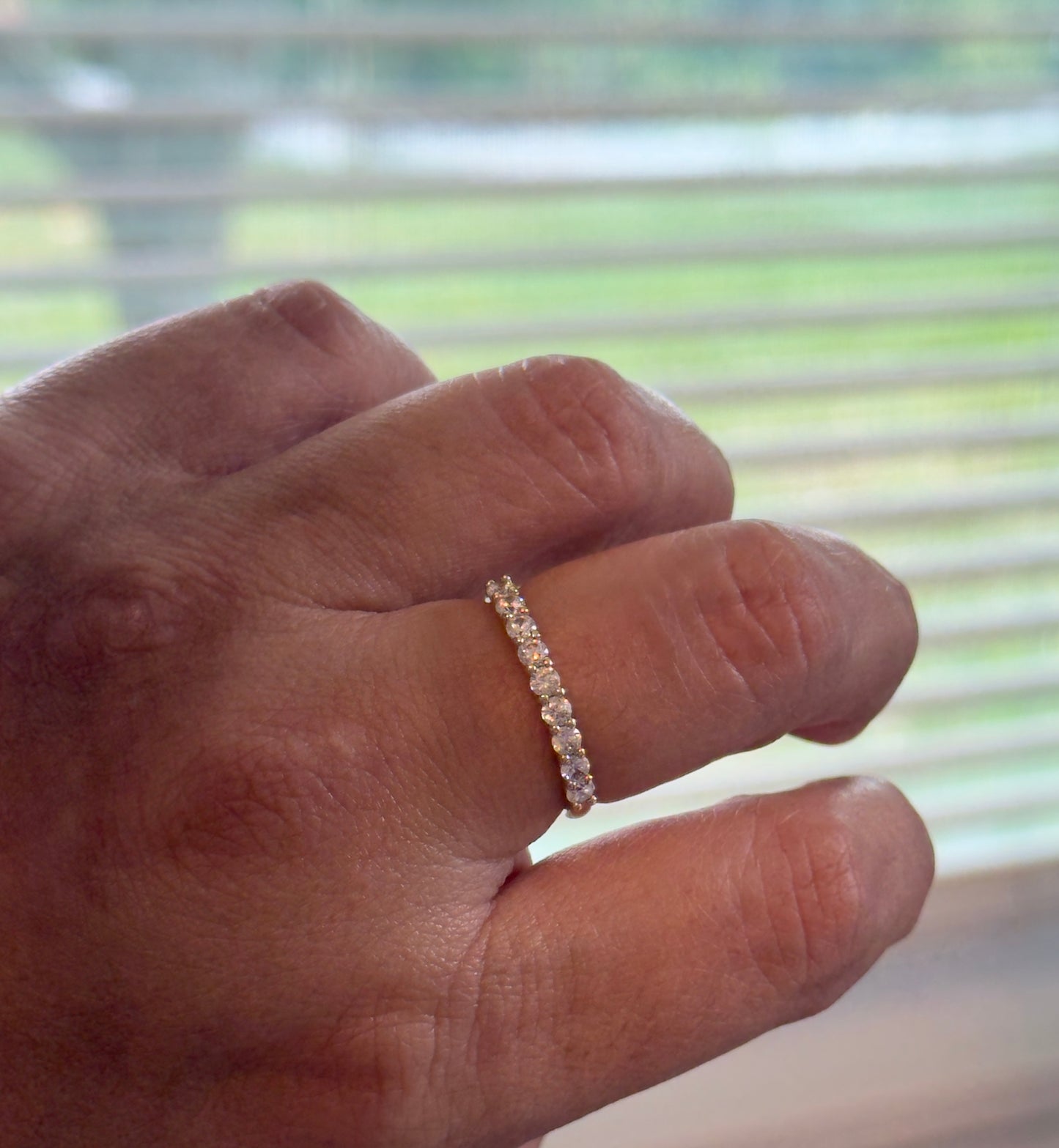 A timeless eternity band featuring sparkling clear stones set in 14KT gold plating. Elegant, stackable, and made for everyday wear.