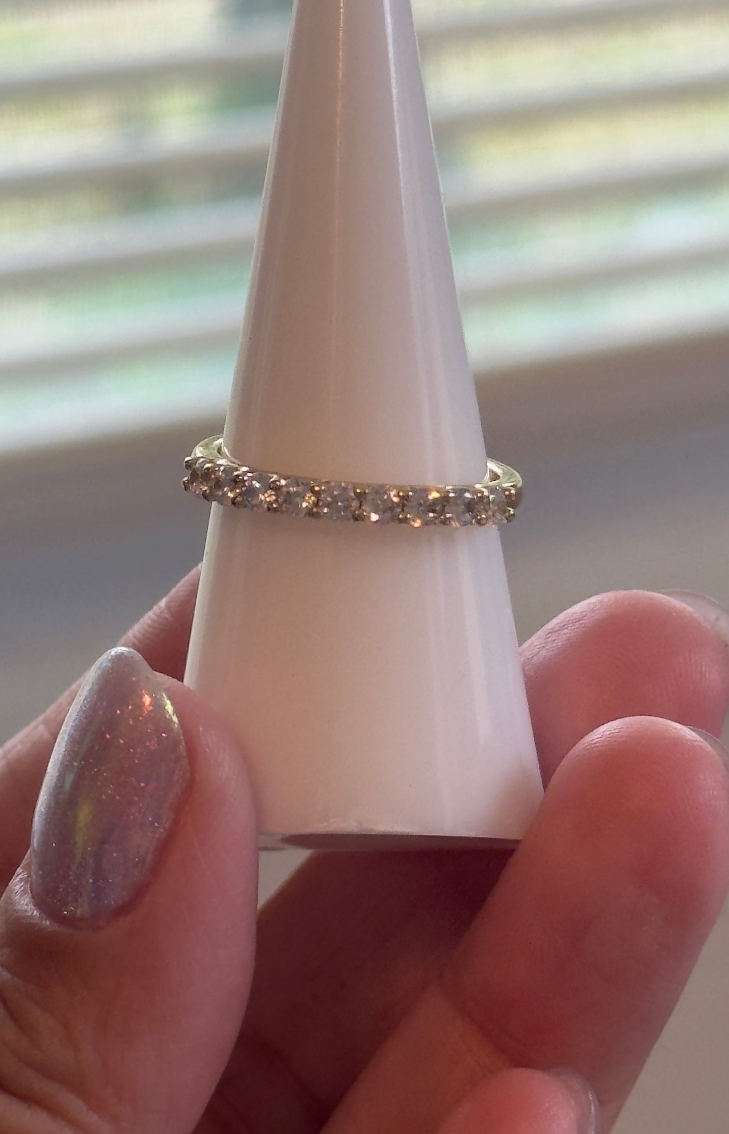 A timeless eternity band featuring sparkling clear stones set in 14KT gold plating. Elegant, stackable, and made for everyday wear.