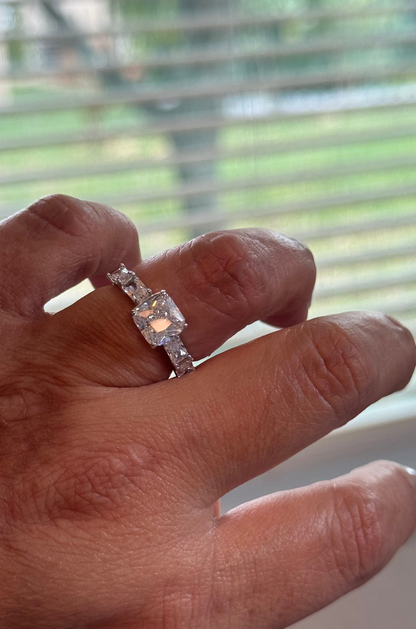 A statement square-cut CZ solitaire ring with elegant baguette side stones. Timeless sparkle with everyday durability.